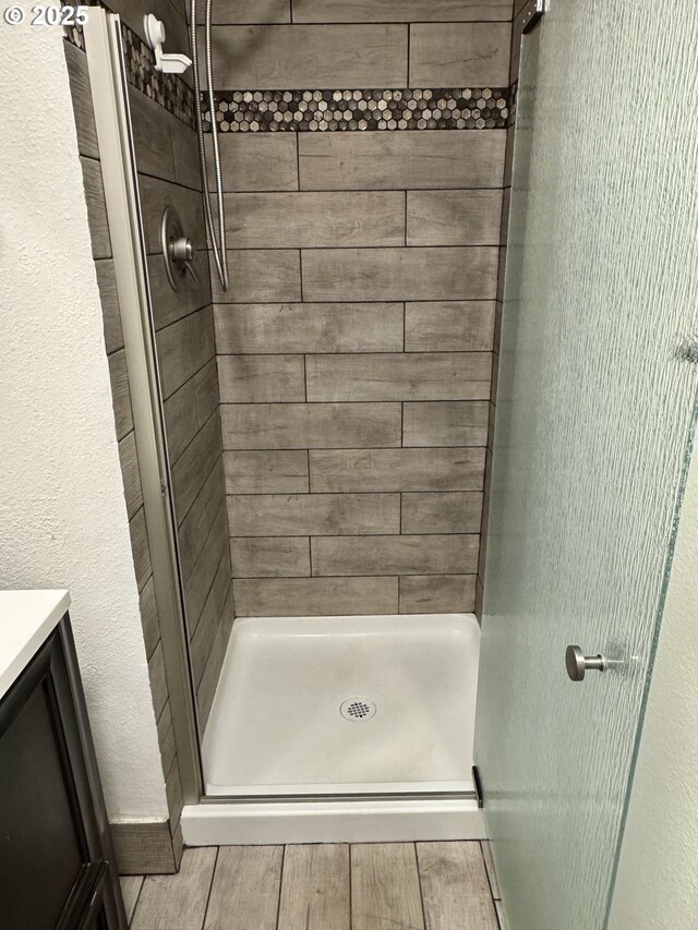 15400 SE Barlow Ct, Damascus, OR 97089 - full bath with a stall shower, vanity, and wood finished floors