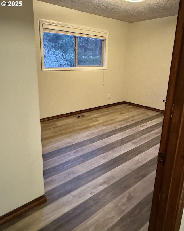 15400 SE Barlow Ct, Damascus, OR 97089 - empty room with a textured ceiling and wood finished floors