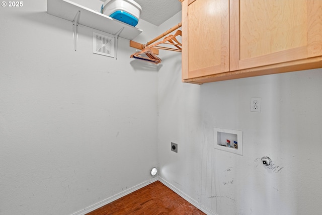 clothes washing area featuring electric dryer hookup, cabinet space, hookup for a washing machine, baseboards, and dark wood-style floors
