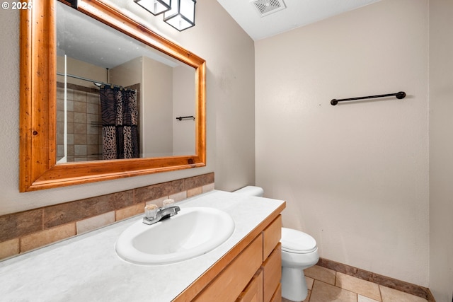 full bath featuring toilet, vanity, visible vents, tile patterned flooring, and baseboards