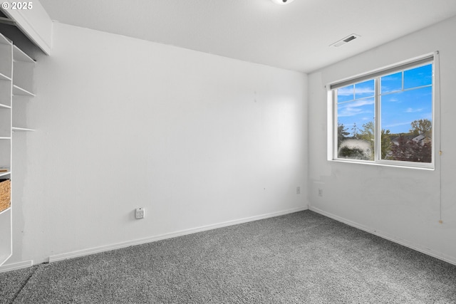 unfurnished room with carpet floors, baseboards, and visible vents