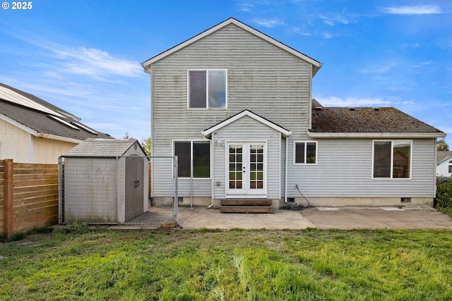 back of property with a patio area, fence, french doors, a shed, and a lawn