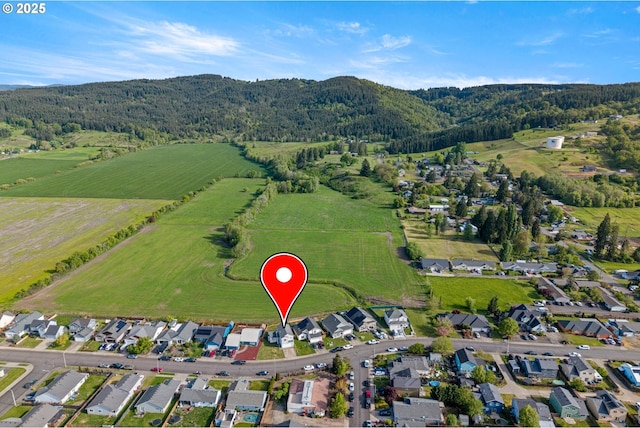 aerial view with a mountain view, a wooded view, and a residential view