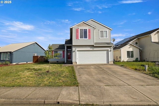 traditional-style house with a front yard, driveway, fence, and a garage
