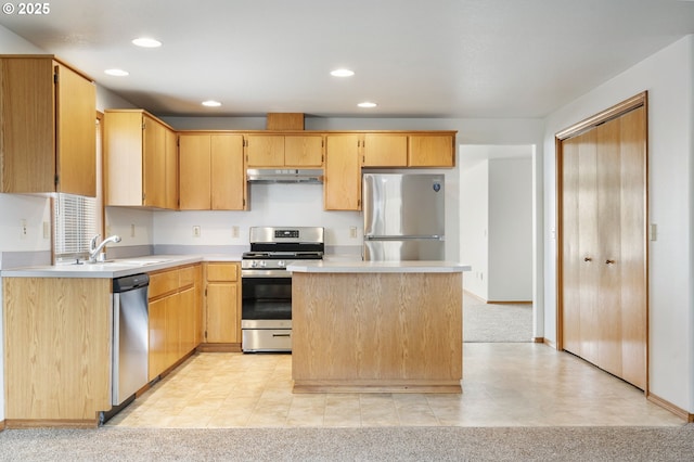 kitchen featuring light colored carpet, under cabinet range hood, a sink, light countertops, and appliances with stainless steel finishes