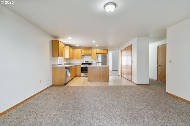 kitchen featuring stainless steel appliances, recessed lighting, light countertops, light carpet, and under cabinet range hood