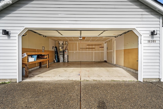 garage with water heater and a garage door opener