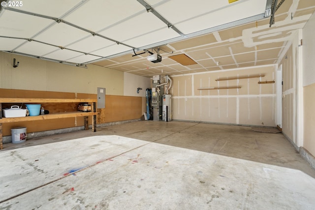 garage featuring water heater, electric panel, and a garage door opener