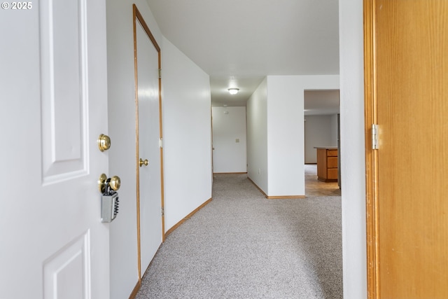 corridor featuring carpet floors and baseboards