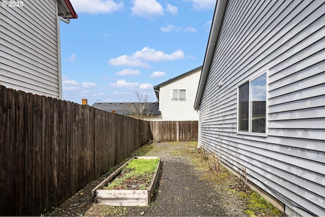 view of yard with a fenced backyard and a vegetable garden