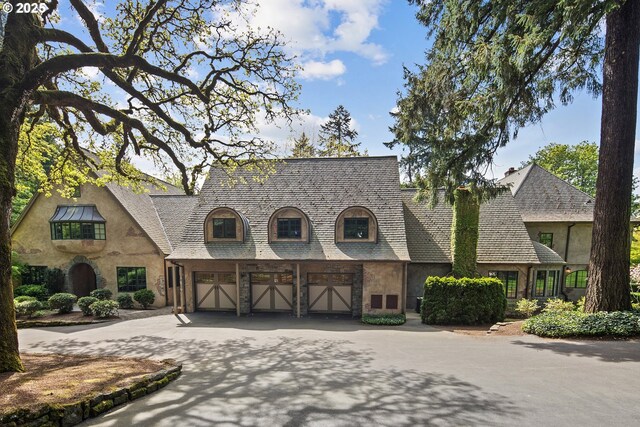 1500 SE Waverly Dr, Milwaukie, OR 97222 - view of front facade with asphalt driveway, an attached garage, and stucco siding