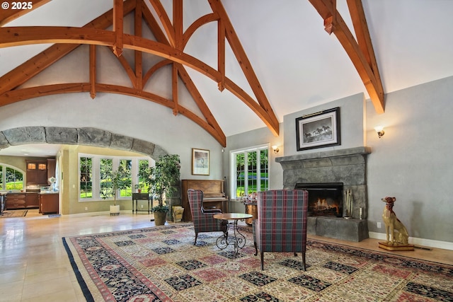 1500 SE Waverly Dr, Milwaukie, OR 97222 - living area featuring beamed ceiling, a lit fireplace, and high vaulted ceiling