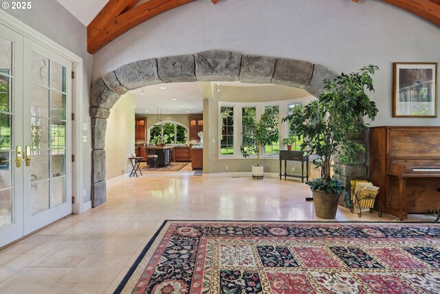 1500 SE Waverly Dr, Milwaukie, OR 97222 - foyer entrance with french doors, arched walkways, high vaulted ceiling, tile patterned flooring, and baseboards
