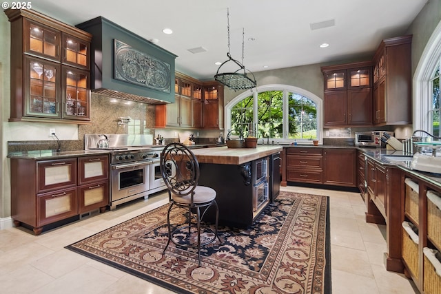 1500 SE Waverly Dr, Milwaukie, OR 97222 - kitchen featuring range with two ovens, wooden counters, recessed lighting, decorative backsplash, and a sink