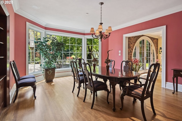 1500 SE Waverly Dr, Milwaukie, OR 97222 - dining room featuring a chandelier, wood finished floors, healthy amount of natural light, and crown molding