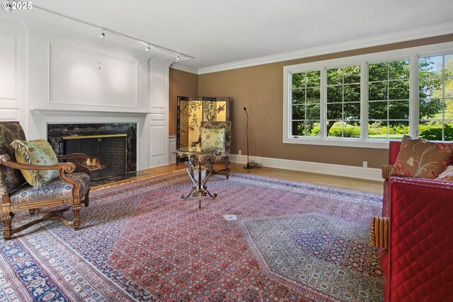 1500 SE Waverly Dr, Milwaukie, OR 97222 - living area with baseboards, a high end fireplace, wood finished floors, and crown molding