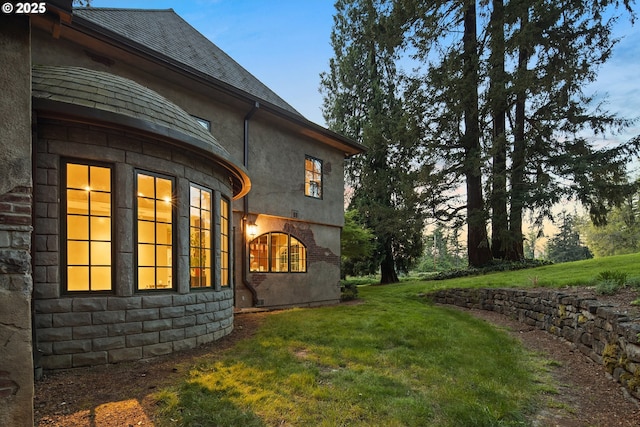 1500 SE Waverly Dr, Milwaukie, OR 97222 - property exterior at dusk with a lawn, stone siding, and stucco siding