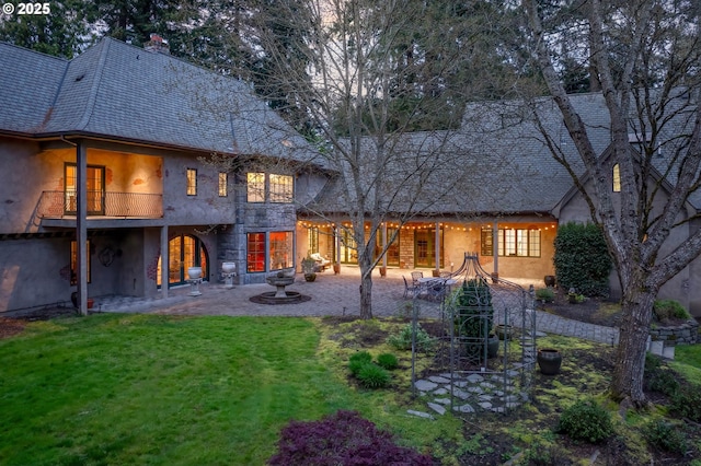 1500 SE Waverly Dr, Milwaukie, OR 97222 - back of house with stucco siding, a yard, a chimney, and a balcony