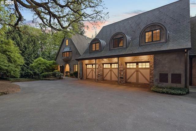 1500 SE Waverly Dr, Milwaukie, OR 97222 - view of front of home with driveway, stone siding, and a garage