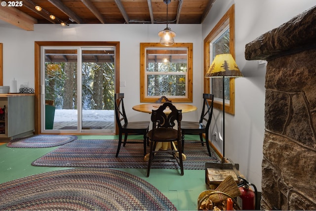 dining area with wooden ceiling and beam ceiling