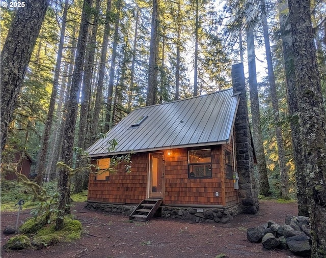78596 E Rd 32, Government Camp, OR 97028 - view of front of property featuring a chimney, a view of trees, and entry steps