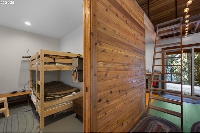 bedroom featuring wooden walls