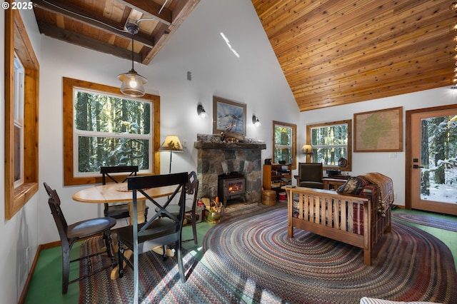 interior space featuring high vaulted ceiling, wooden ceiling, a fireplace, and beam ceiling