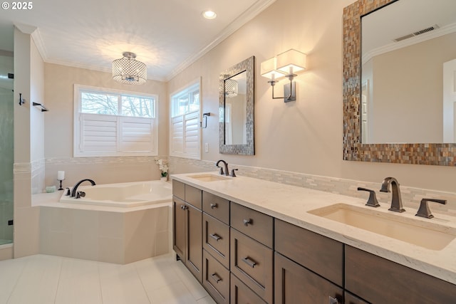 bathroom with vanity, tiled tub, crown molding, and tile patterned floors