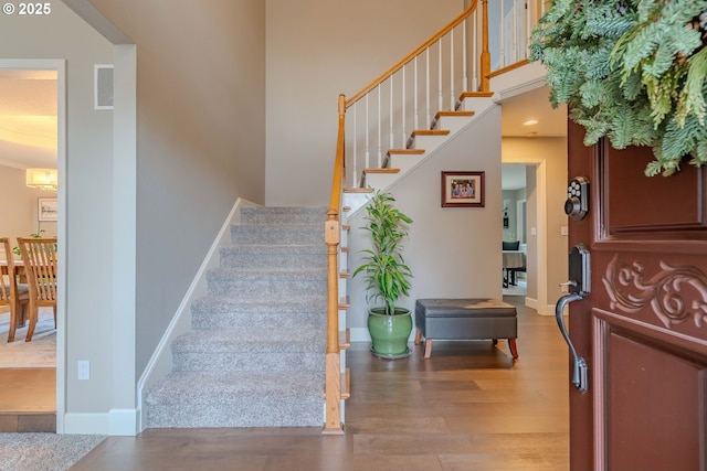 stairs featuring wood-type flooring