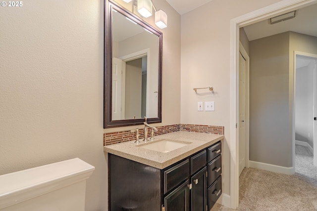 bathroom featuring vanity and decorative backsplash