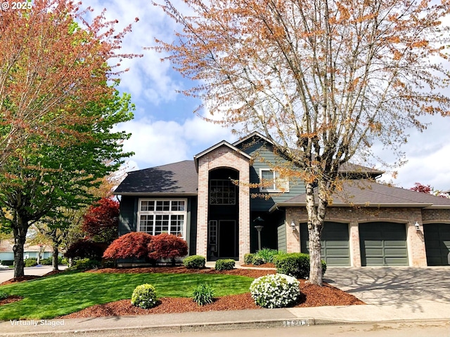 view of front facade with a garage and a front lawn