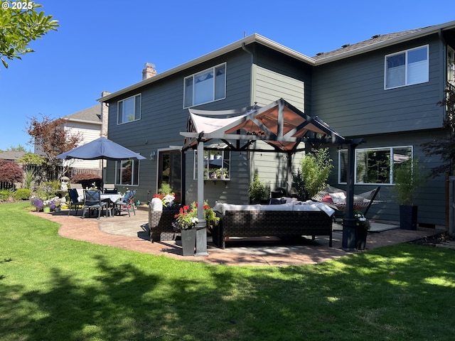 rear view of house featuring an outdoor living space, a patio, and a lawn