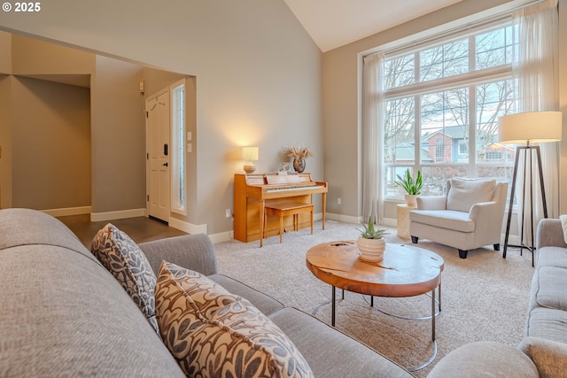 carpeted living room with vaulted ceiling