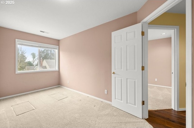 unfurnished bedroom featuring visible vents, carpet flooring, and baseboards