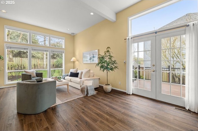 living room featuring visible vents, beam ceiling, wood finished floors, french doors, and baseboards