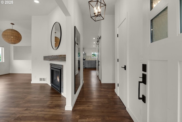 657 Summit Ave, Gearhart, OR 97138 - hall with a chandelier, dark wood-style flooring, recessed lighting, and baseboards