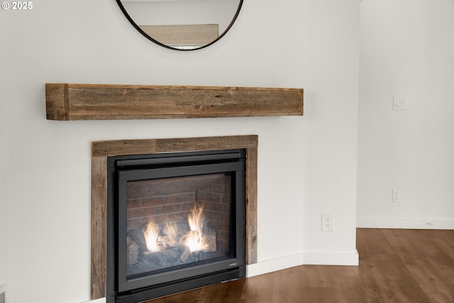 657 Summit Ave, Gearhart, OR 97138 - detailed view of wood finished floors, baseboards, and a warm lit fireplace