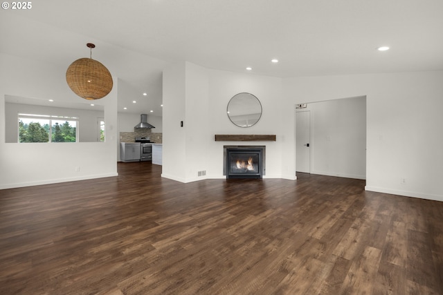 657 Summit Ave, Gearhart, OR 97138 - unfurnished living room featuring recessed lighting, a glass covered fireplace, dark wood finished floors, and baseboards