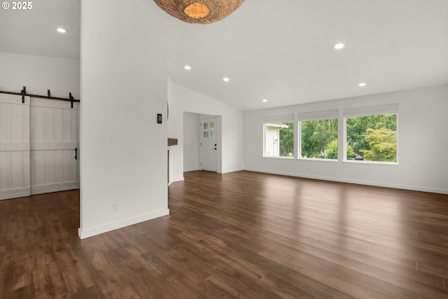 657 Summit Ave, Gearhart, OR 97138 - unfurnished living room with a barn door, wood finished floors, recessed lighting, lofted ceiling, and baseboards