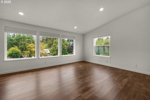 657 Summit Ave, Gearhart, OR 97138 - unfurnished room featuring dark wood-style floors, baseboards, recessed lighting, vaulted ceiling, and a textured ceiling