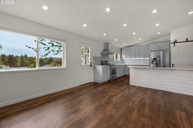 657 Summit Ave, Gearhart, OR 97138 - kitchen featuring appliances with stainless steel finishes, ventilation hood, gray cabinetry, a barn door, and light countertops