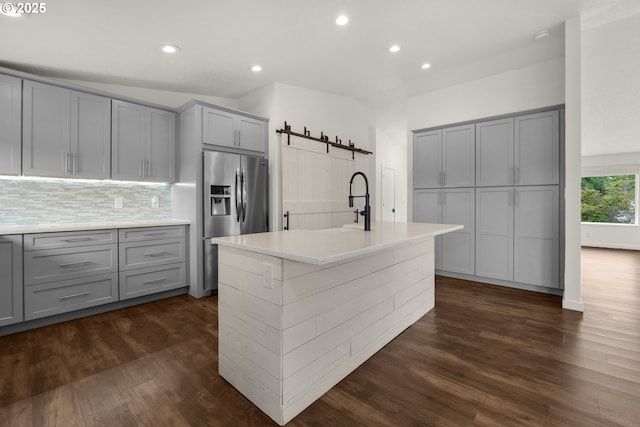 657 Summit Ave, Gearhart, OR 97138 - kitchen with gray cabinets, stainless steel fridge with ice dispenser, a barn door, dark wood-style floors, and recessed lighting