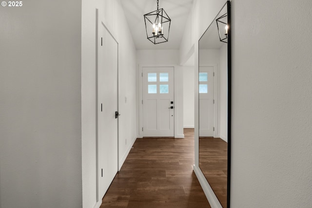 657 Summit Ave, Gearhart, OR 97138 - doorway featuring a chandelier, dark wood-style flooring, and baseboards