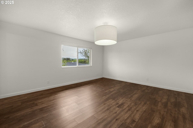 657 Summit Ave, Gearhart, OR 97138 - empty room featuring dark wood-style flooring and baseboards