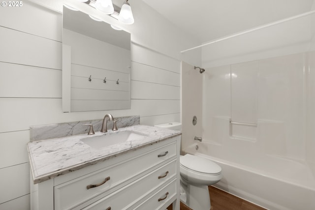 657 Summit Ave, Gearhart, OR 97138 - bathroom with toilet, vanity, bathtub / shower combination, and wood finished floors