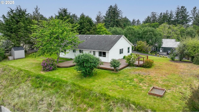 657 Summit Ave, Gearhart, OR 97138 - back of property featuring a yard, a deck, and a vegetable garden