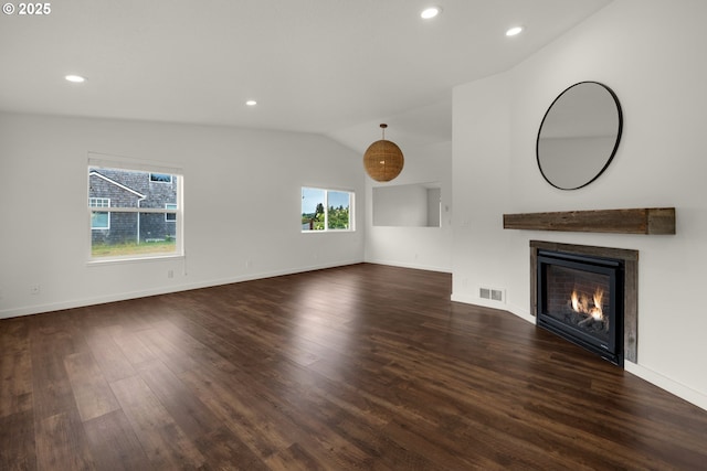 657 Summit Ave, Gearhart, OR 97138 - unfurnished living room with dark wood finished floors, recessed lighting, a lit fireplace, and lofted ceiling