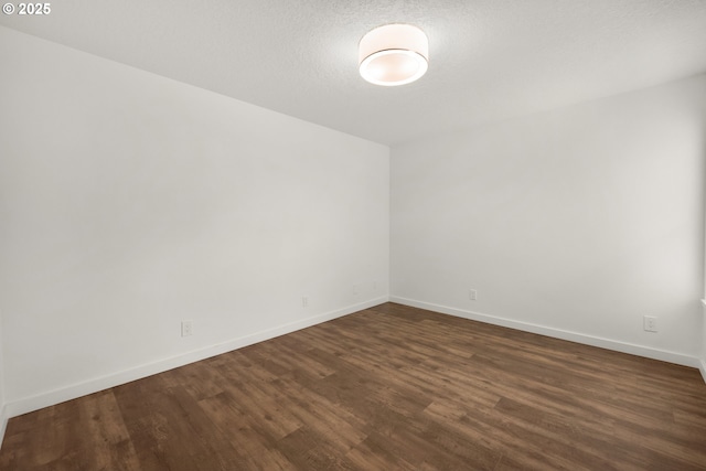 657 Summit Ave, Gearhart, OR 97138 - empty room featuring dark wood-style floors and baseboards