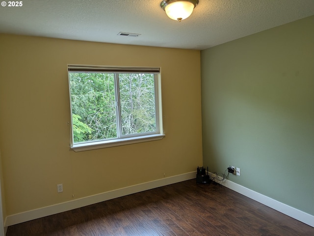 17458 SW Inkster Dr, Sherwood, OR 97140 - spare room featuring healthy amount of natural light, dark wood-style floors, and a textured ceiling