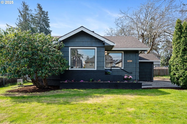 7612 SE Carlton St, Portland, OR 97206 - view of front of house featuring roof with shingles, a front lawn, and fence